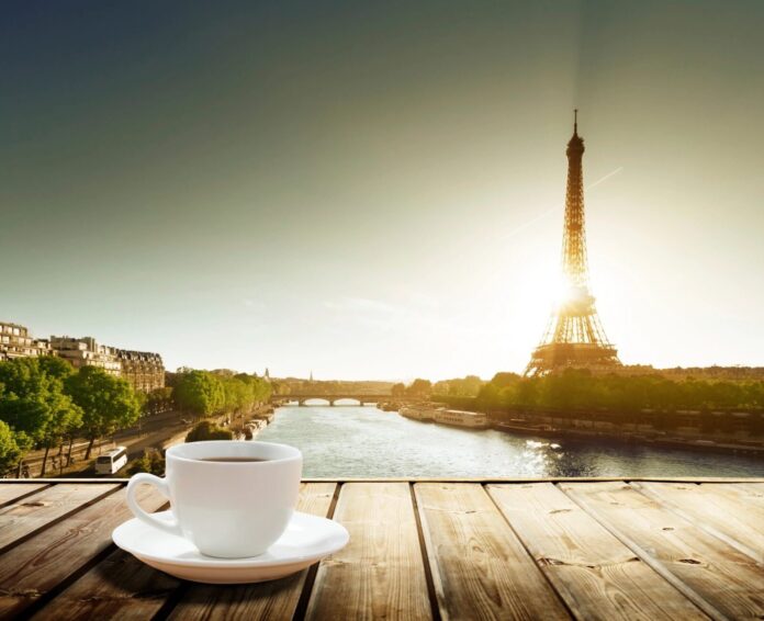 Coffee cup with Eiffel Tower background.