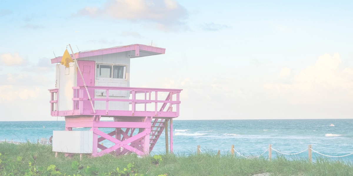 white and pink color house near the sea