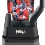 Close-up of a Ninja blender filled with mixed berries.